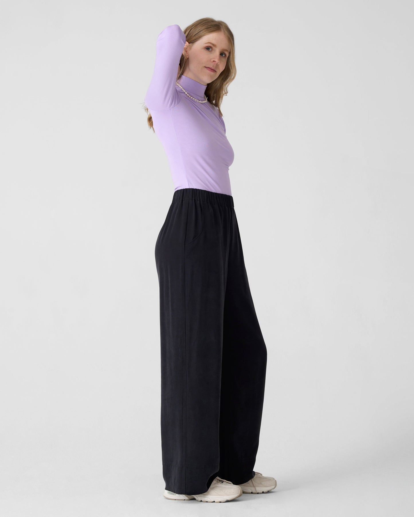 Wide black pants for women with elastic waist. DV. Lilac long sleeve turtleneck top. 